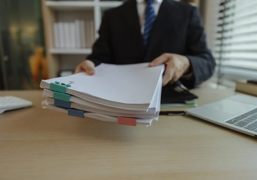 Businessman dressed in a suit is working in an office at a company. A senior executive is in a private office and doing many things. The atmosphere of a private office is calm and peaceful.