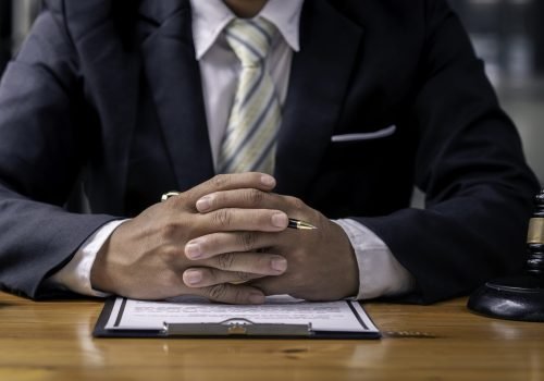 Lawyer Sitting At Table, Judge gavel with Justice lawyers, Businessman in suit or lawyer working on documents. Legal law, advice, and justice concept