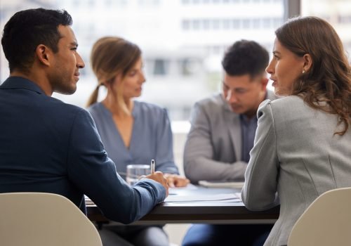 Shot of a diverse group of businesspeople sitting together in the office and having a meeting.